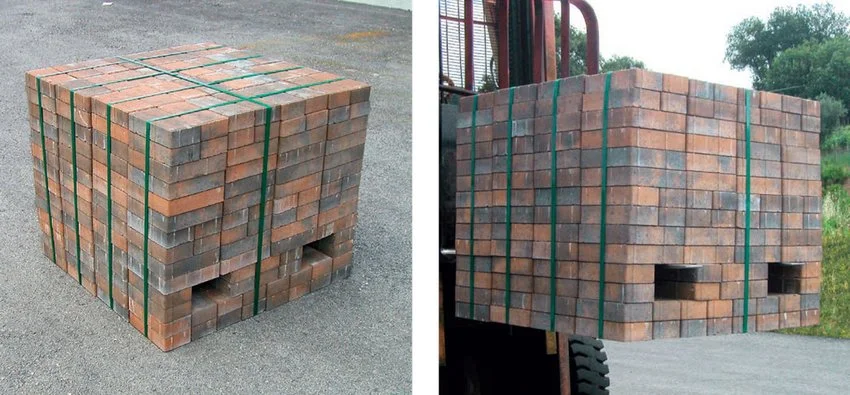 Pallets of bricks secured with green straps running vertically